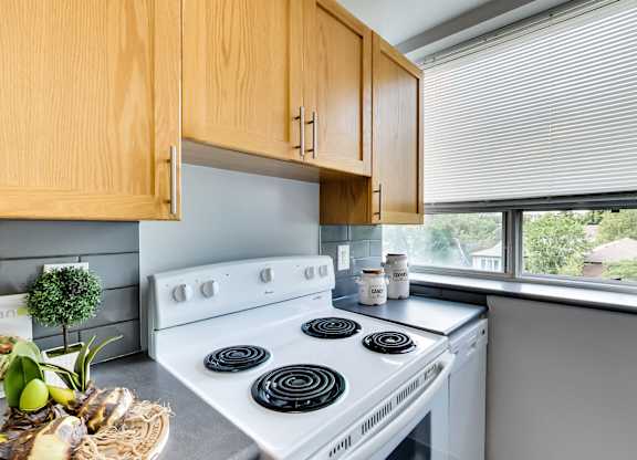a kitchen with a white stove and a window