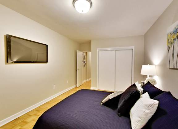 a bedroom with a large bed and a tv