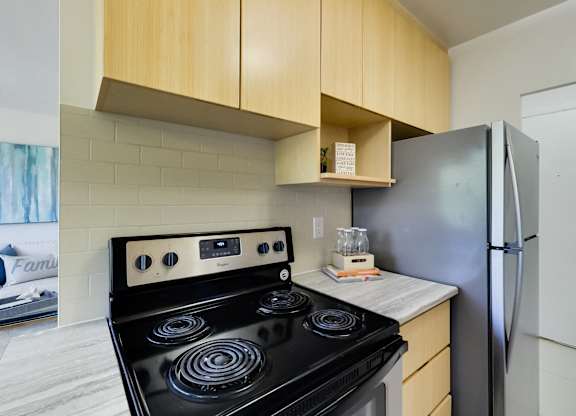a kitchen with a stove and a refrigerator
