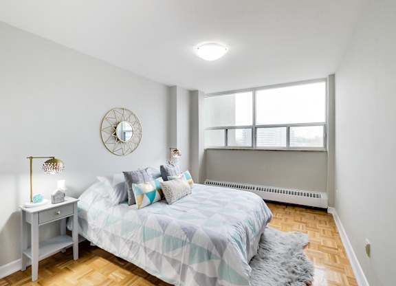 a bedroom with a large bed and a window