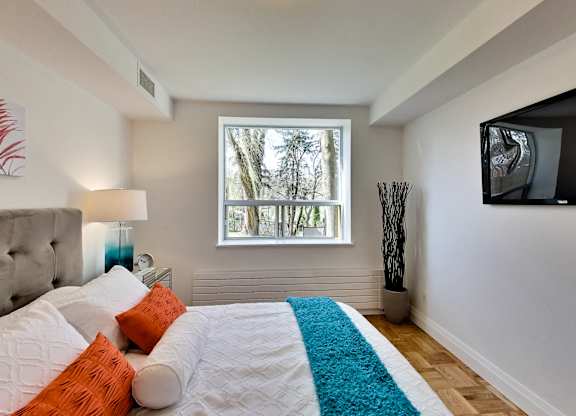 a bedroom with a large bed and a window