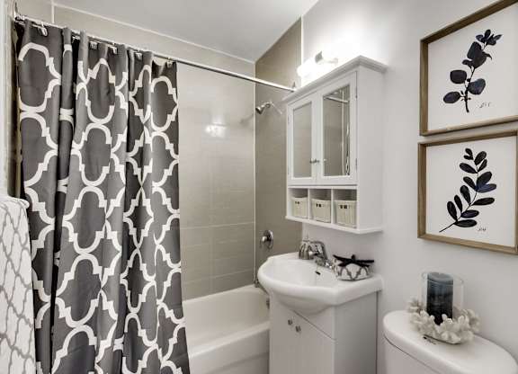 a white bathroom with a black and white shower curtain