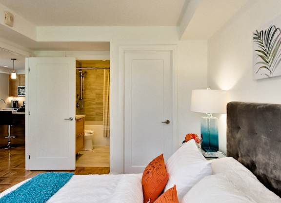 a bedroom with a bed and a bathroom with a shower