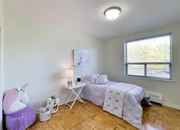 a bedroom with a bed and a unicorn chair