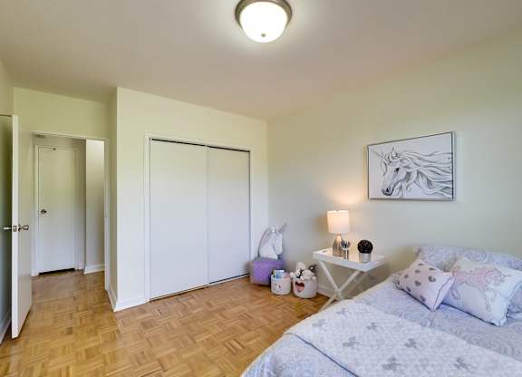 a bedroom with a bed and a closet