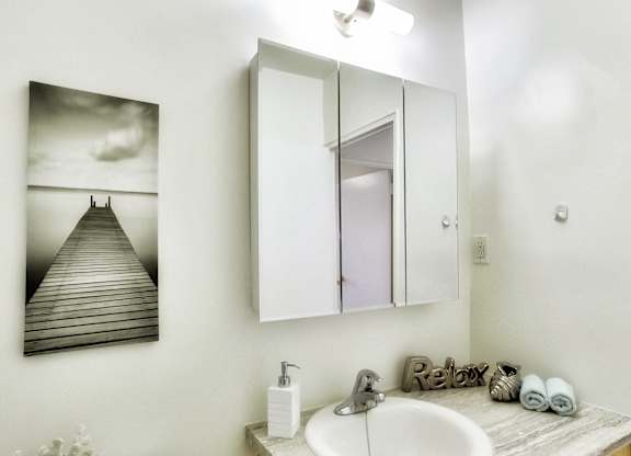 an image of a bathroom with a sink and a mirror