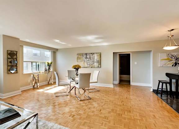 a dining room and living room with a table and chairs