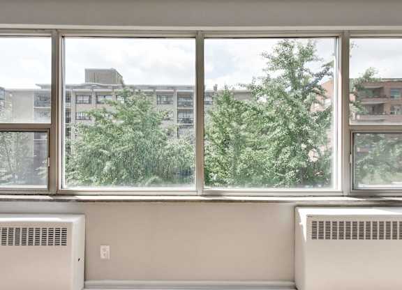 a room with a large window and a view of trees