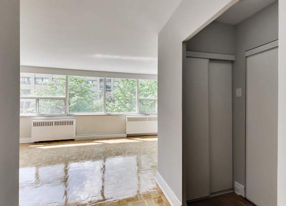 a living room with a large window and a door