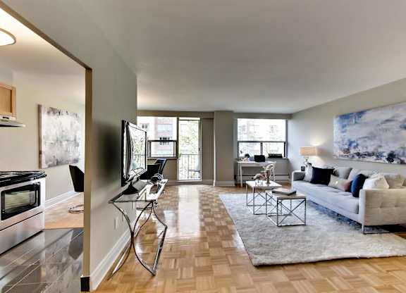 a living room with a couch and a chair and a tv