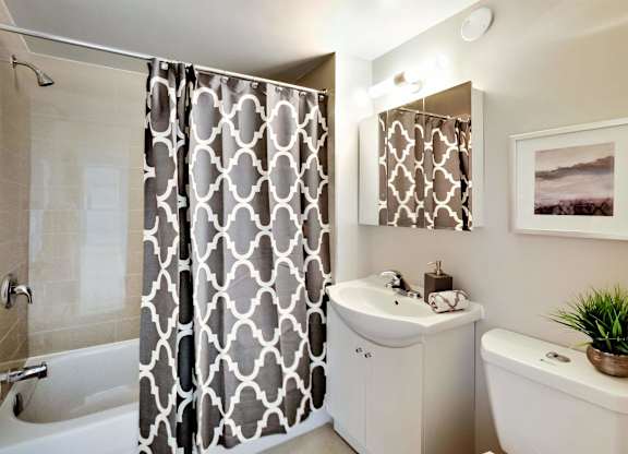 a bathroom with a shower and a sink and a toilet