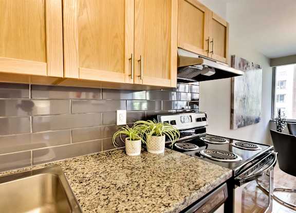a kitchen with granite counter tops and a stove top oven
