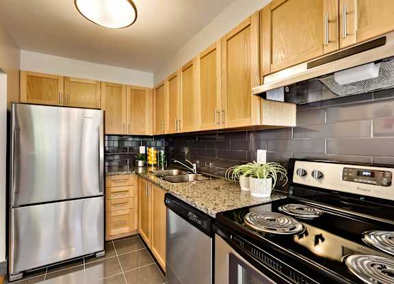 a kitchen with stainless steel appliances and wooden cabinets