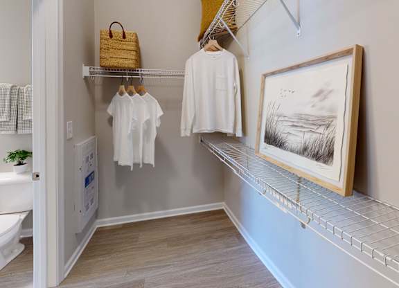 a large walk-in closet with racks and shelves