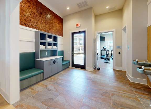 a clubhouse hallway leading to the 24-hour fitness center
