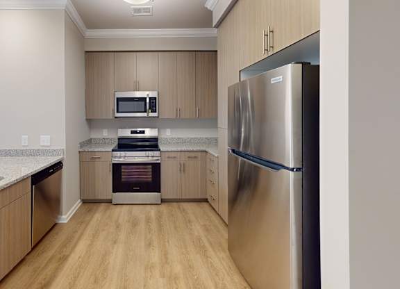 a designer kitchen with granite countertops and stainless steel appliances