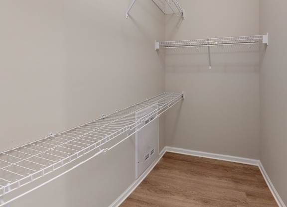 a large walk-in closet with shelving
