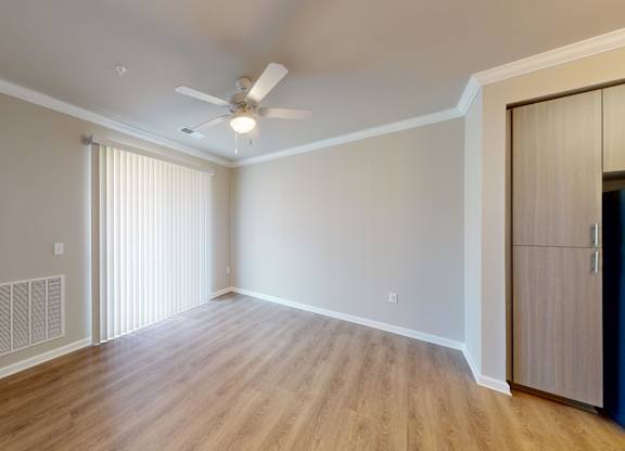 a living room with luxury vinyl flooring and ceiling fan