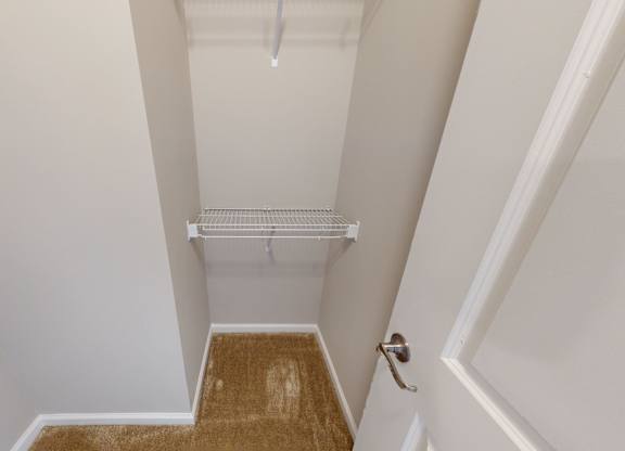 a walk-in closet with shelving
