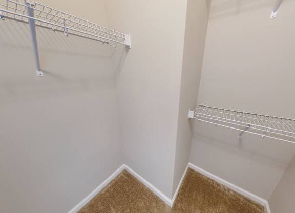 a walk-in closet with shelving