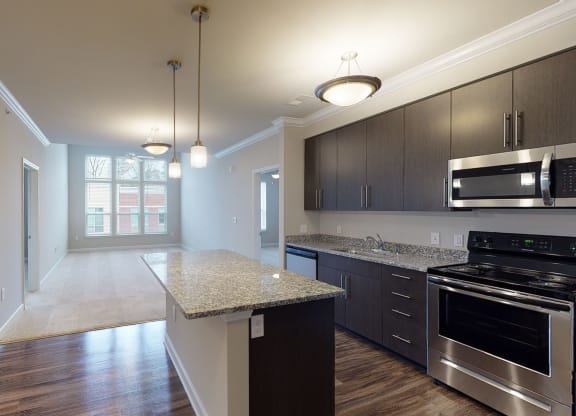 Kitchen with island open to the main living area with sunroom
