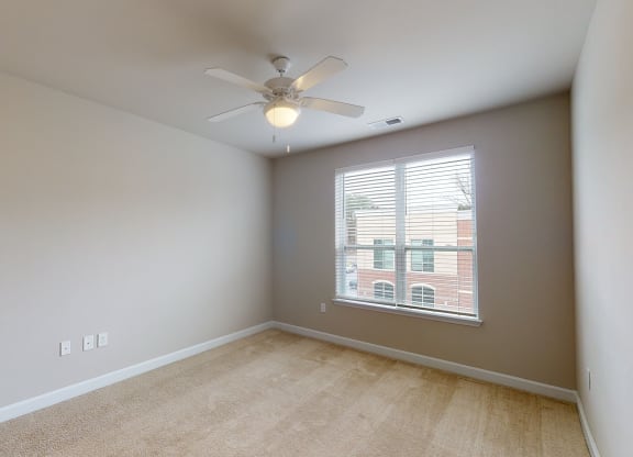 Bedroom with ceiling fan, carpet and window