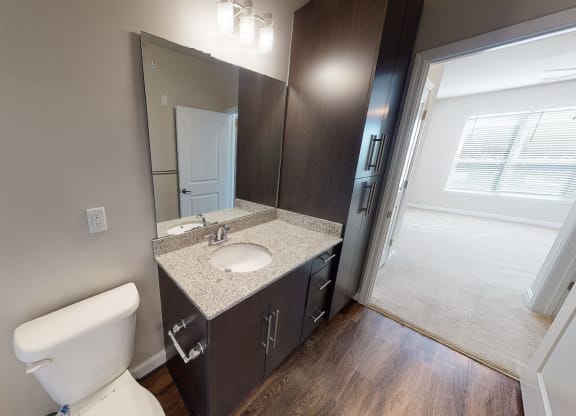 Bathroom with sink, toilet and storage cabinet