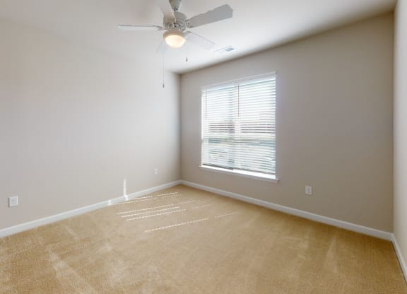 Bedroom with ceiling fan, carpet and window