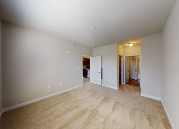 Bedroom with carpet; door to bathroom