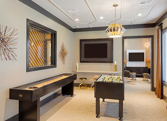 Game room with foosball table, shuffleboard, flat screen TVs