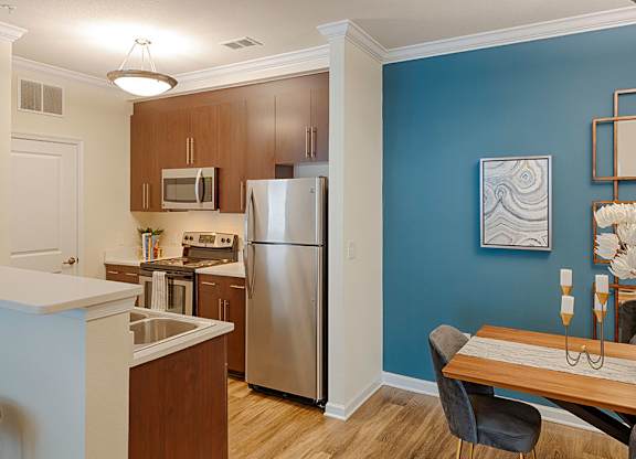 Dining room and kitchen with stainless steel appliances