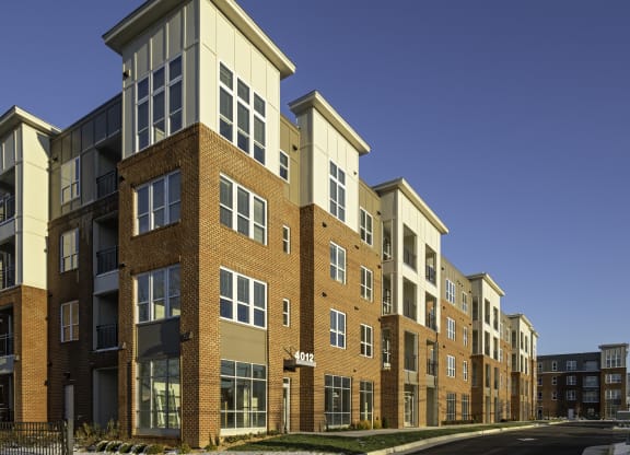 Exterior of four-story building with retail space available on the first floor