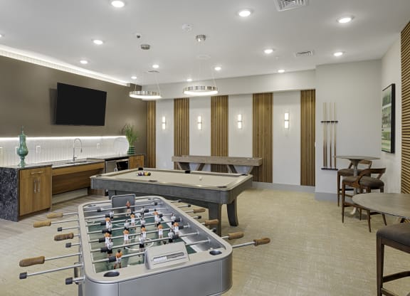 Game room with foosball table, billiards, shuffleboard, flat screen TV