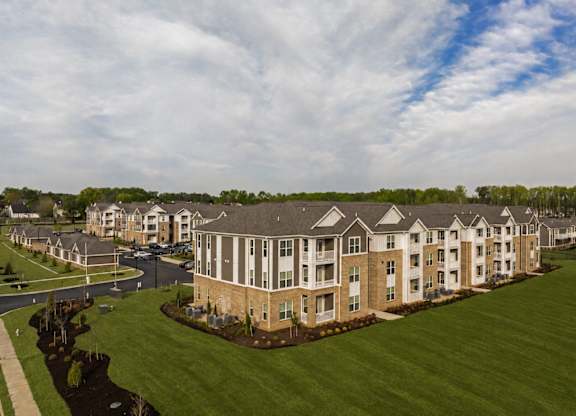 A large apartment complex with multiple buildings and green lawns.