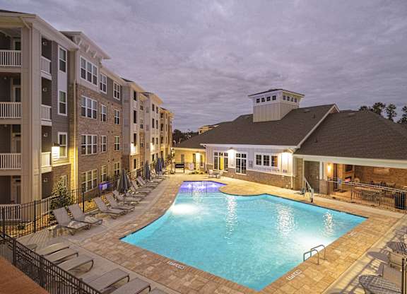 a resort style pool with lounge chairs