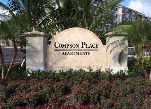 A sign that says Compson Place Apartments.