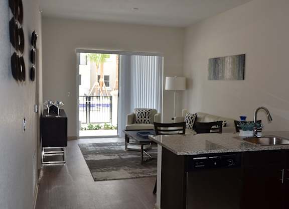 A living room with a sliding door leading to a patio.