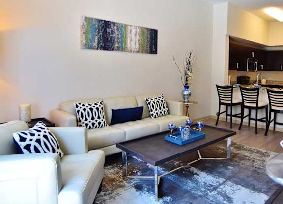 A living room with a white couch and a coffee table.