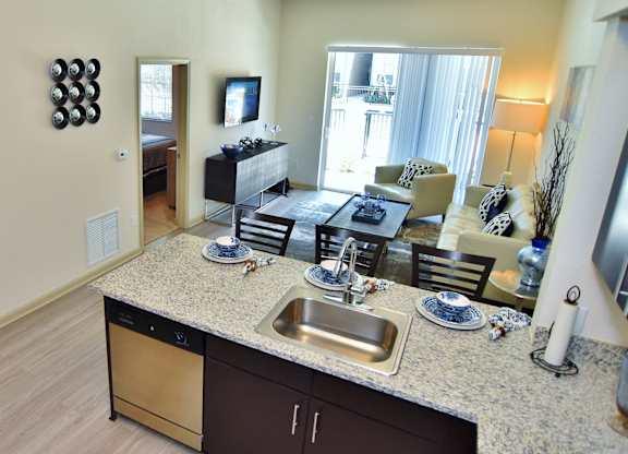 A kitchen with a sink and a counter.