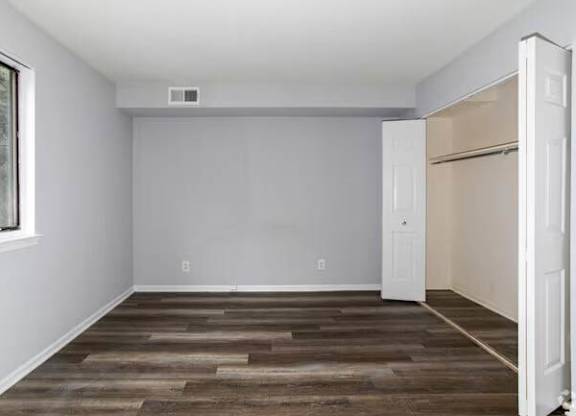 A room with a wooden floor and a white door at Brookshire Trace Townhomes Apartments, Pennsylvania