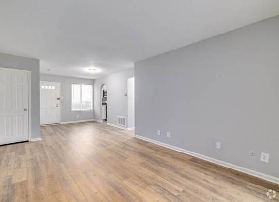 A room with wooden flooring and white walls at Brookshire Trace Townhomes Apartments, Philadelphia, 19116