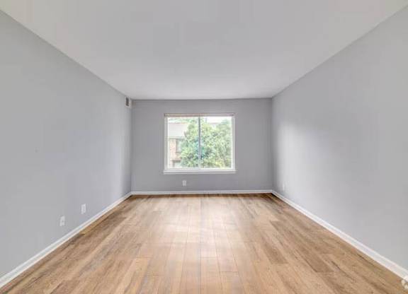 A room with wooden flooring and a window at Brookshire Trace Townhomes Apartments, Philadelphia, Pennsylvania