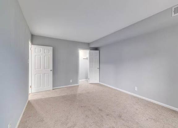 A room with two doors and carpeted floor at Brookshire Trace Townhomes Apartments, Pennsylvania, 19116