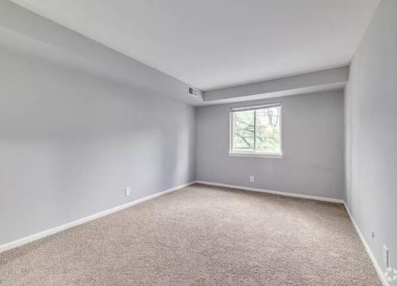 A room with a window and carpeted floor at Brookshire Trace Townhomes Apartments, Philadelphia, PA, 19116