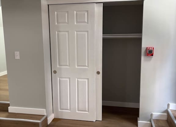 A white door is in a room with wooden floors.at Lawndale Apartments, Philadelphia, PA 19111