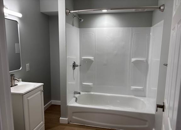 A white bathroom with a walk-in shower and a toilet.at Lawndale Apartments, Pennsylvania, 19111