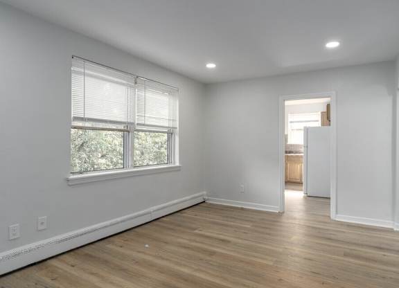 A room with a window and wooden floors.at Lawndale Apartments, Philadelphia, PA 19111