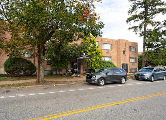 A black car is parked on the side of the road at Manchester Apartments, Philadelphia