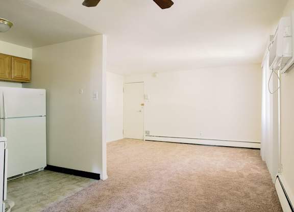 a kitchen with a white refrigerator and a white door at Krewstown Park Apartments, Philadelphia, PA