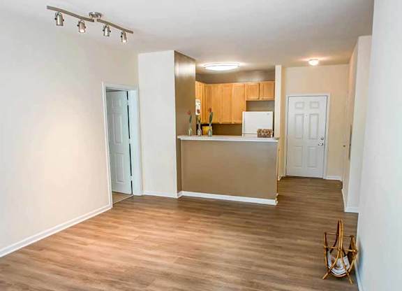 an empty living room and kitchen with a wood floor at Riverview Landing @ Valley Forge, Pennsylvania